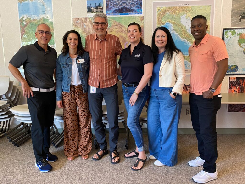 Roger Arbabi of Park City High School with the EOS team he partners with.